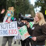 (Photo by Luisa Loi)
At right, Leilani Floyd, a junior at the high school, speaks to the crowd that joined her protest against the Trump Administration. At left, Joy! Palmer holds a sign that says Protect trans kids.