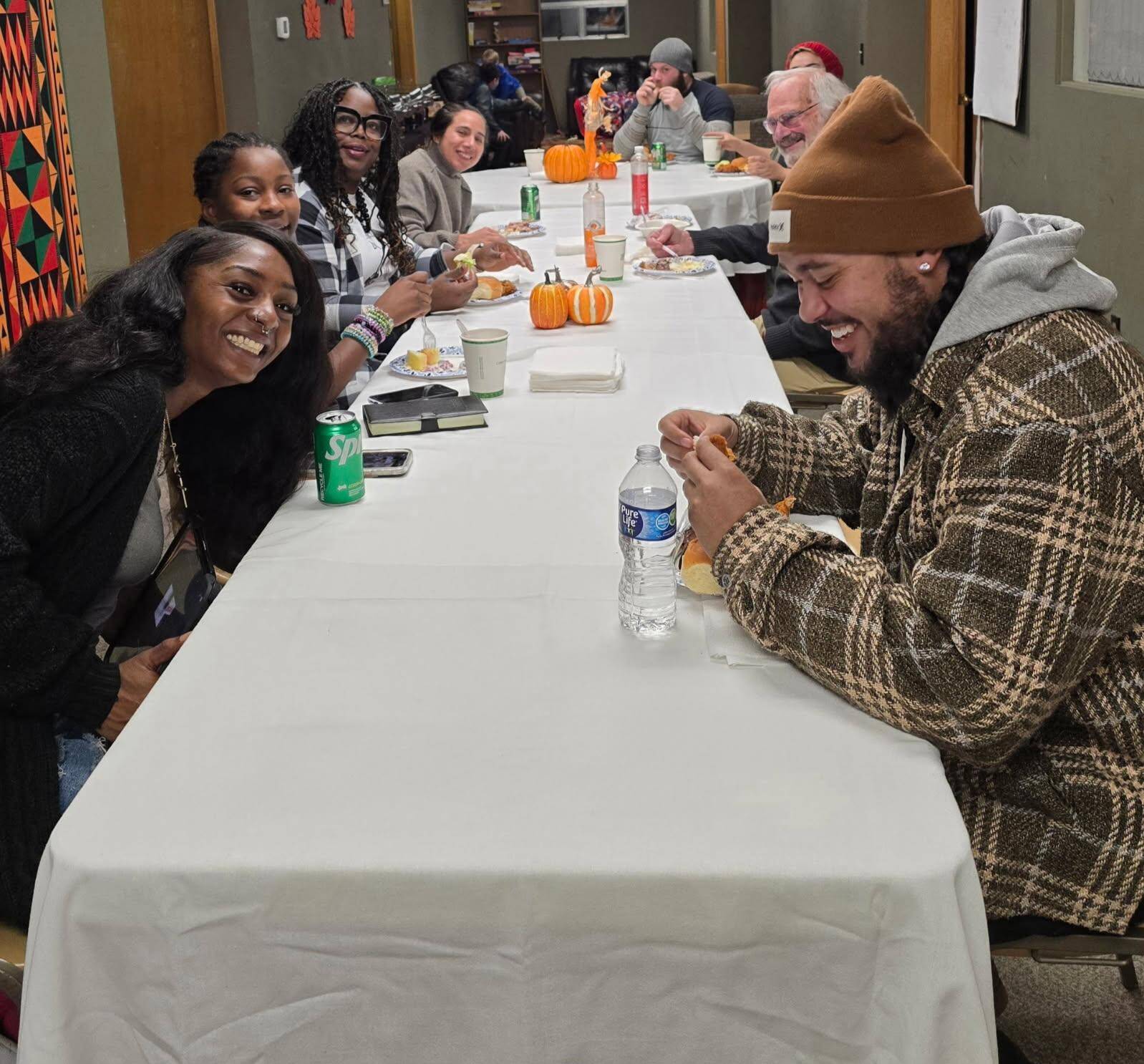(Photo by Diane Jhueck)
Participants of a previous Pamoja Place community event gather around the table.
