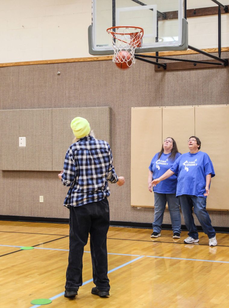 (Photo by Luisa Loi)
At right, Coach Shari Mays and Assistant Coach Kathy Nord watch in awe as Lance Maly sinks a basket. According to Mays, the athletes tend to do even better at torunaments.