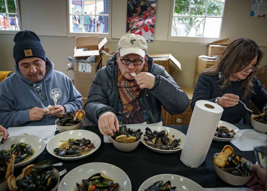 Judges try the mussel dishes before choosing the winner of the Mussel Tussle. The seven judges were selected from the audience.