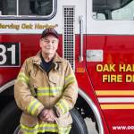 (Photo by Luisa Loi)
Rich Rodgers stands in his gear in front of a 1993 ladder truck at Fire Station 81.