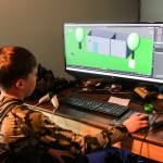 (Photo by Luisa Loi)
Ryan demonstrates how, without any prior experience, he learned to build each block and shape on his computer screen before transferring the diorama to his virtual reality set.