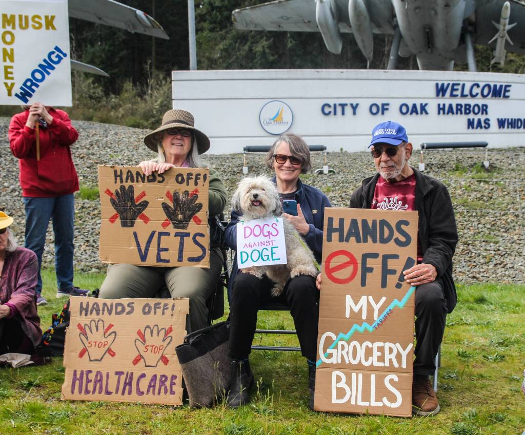 At left, Suzanne Fageol, Peggy Taylor, doge Havi and Rick Ingrasci smile in front of the Navy aircraft monument. (Photo by Luisa Loi)