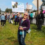A woman holds a sign demanding the federal government to keep its hands off the VS, healthcare, Social Security, the wilderness, education and the military. (Photo by Luisa Loi)