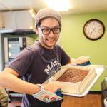 Gene Hainey, owner of Noona Bakery, shows some freshly-baked brownies. (Photo by Luisa Loi)