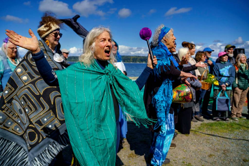 Deborah Koff-Chapin sings and rings the gong. (Photo by David Welton)