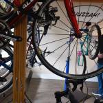 Trevor Stevens checks the wheel alignment on one of the dozens of renovated bicycles he fixes up for resale at his Coupeville store, Celerity Cycles, which opened last week. (Photo by Patricia Guthrie)