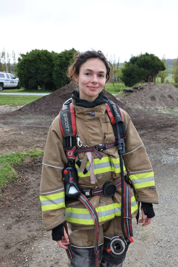 (Photo by John Fisken)
Freelance reporter Luisa Loi poses for a photo after experiencing the first round of fires in the Swanton Road home. As of Monday night, her shoulders still feel sore from carrying the self-contained breathing apparatus. Perhaps its time to hit the gym.