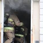 (Photo by John Fisken)
Firefighters venture inside the burning farm house.