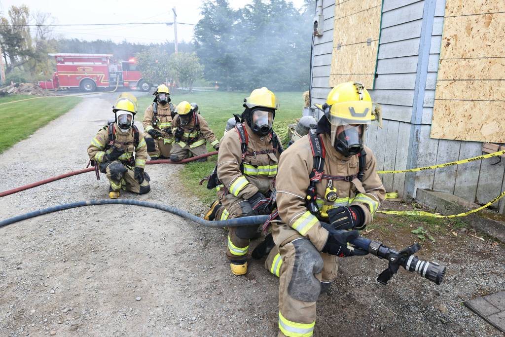 Photo by John Fisken
Firefighters and trainees got to put their skills to the test at a house offered by North Whidbey resident Kris Skrivseth.