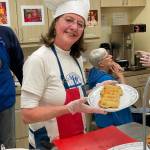 Gail Corell bakes sausage rolls for hungry shoppers.