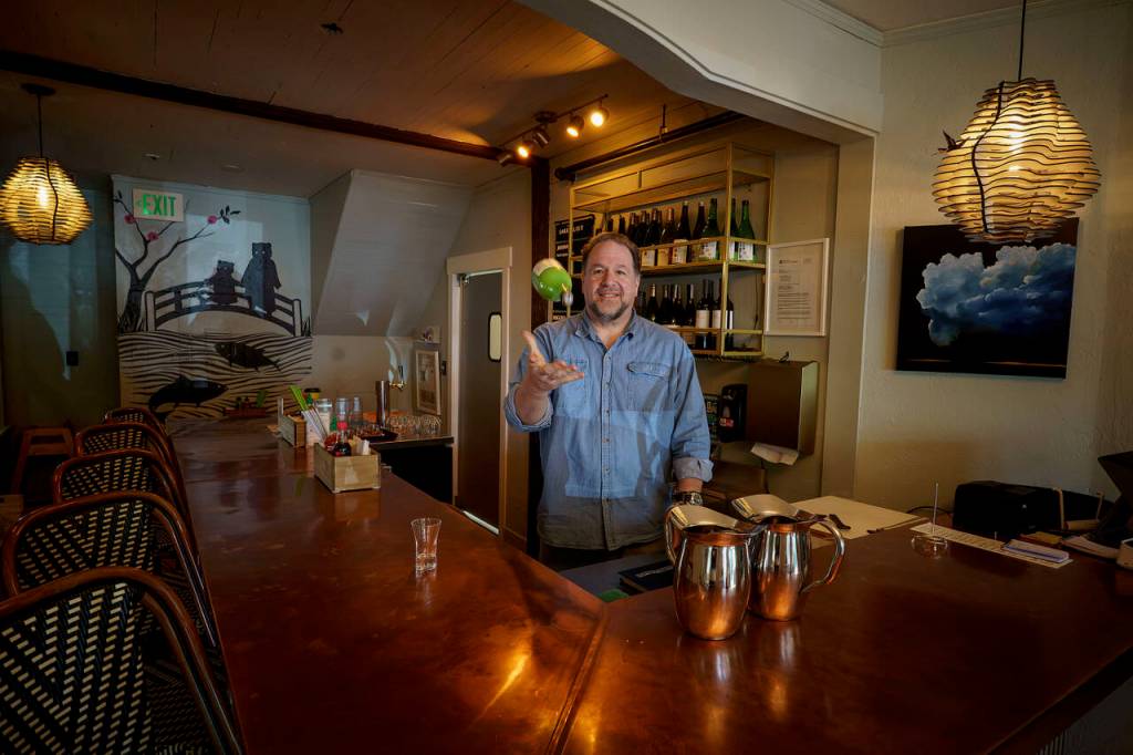 Photo by David Welton
Ed Hodson, sommelier, flips a bottle of wine into the air behind the new bar in Japonica Diner.