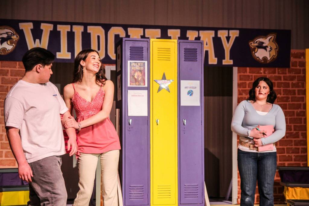 Photo by Luisa Loi
At right, Gabriella Montez (Hadley McCulloch) watches in disbelief and confusion as Sharpay Evans (Adriana Froman) tries to sabotage her budding romance with Troy Bolton (Lucas Smith).