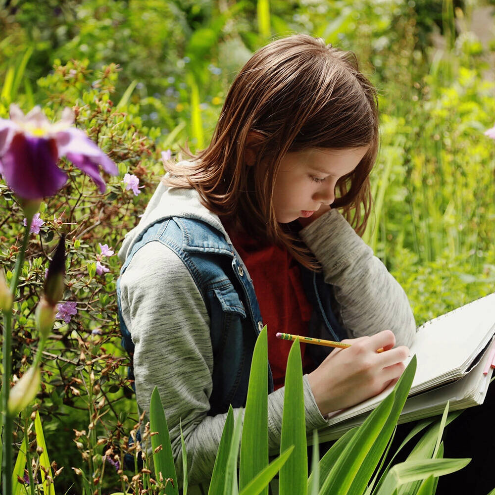 Photo provided
An early childhood student at Whidbey Island Waldorf School works outside on a botany lesson.
