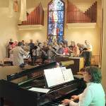 Kathy Fox at the piano in 2015, practicing during a rehearsal led by former music director Bill Humphreys.