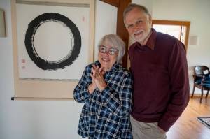 Photo by David Welton
Cynthia and David Daiku Trowbridge, founders of the Tinyblue Foundation, stand before the tapestry that gave Enso House its name.