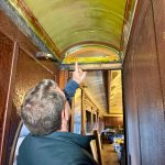 Northwest Railway Museum Executive Director Richard Anderson points to an original piece of ceiling in parlor car 1049, April 29, 2025. (Grace Gorenflo/Valley Record)