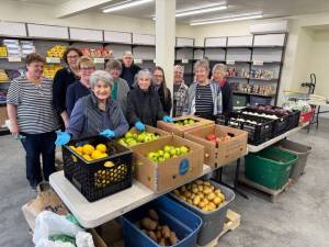 Volunteers at the new Gifts from the Heart food bank, including Coupeville Mayor Molly Hughes (back row, second from left), await their customers on opening day.