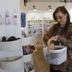 Photo by Kira Erickson/South Whidbey Record
Sarah Jean Muncey-Gordon restocks her shelves in Bandbox Beauty Supply.