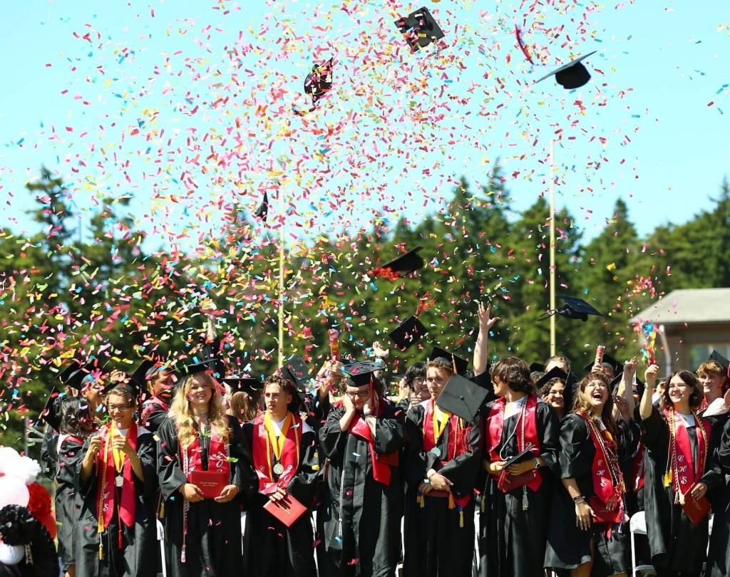 Graduates throw their caps in celebration. (Photo by Marquette Cunningham)