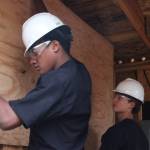 Photo by Marina Blatt.
Students hang up a panel.