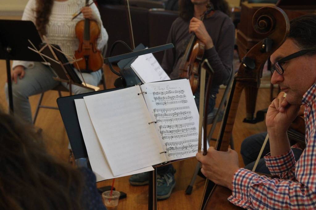 William Skeen with a cello from the 18th century switches his bow from modern to classic (Photo by Allyson Ballard)