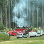 The remains of a house were still smoking the day after an explosion and fire destroyed the structure and killed a man.