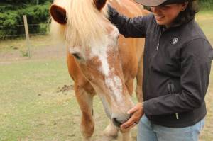 Rhed pets Joel, one of many horses at Big Rhed Barn.
