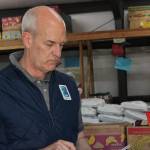 Rick Larsen in the Help Houses warehouse (Photo by Allyson Ballard)