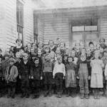 Students stand in front of a schoolhouse that could possibly be the Bayview School (Photo courtesy of the Island County Historical Society)