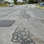 Patches of filled-in asphalt make the road uneven on Southwest Lopez Drive (Photo by Marina Blatt)