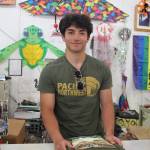 (Photo by Marina Blatt) Cashier Ryan Blouin folds a shirt at Harbor and Gift inside the wharf.