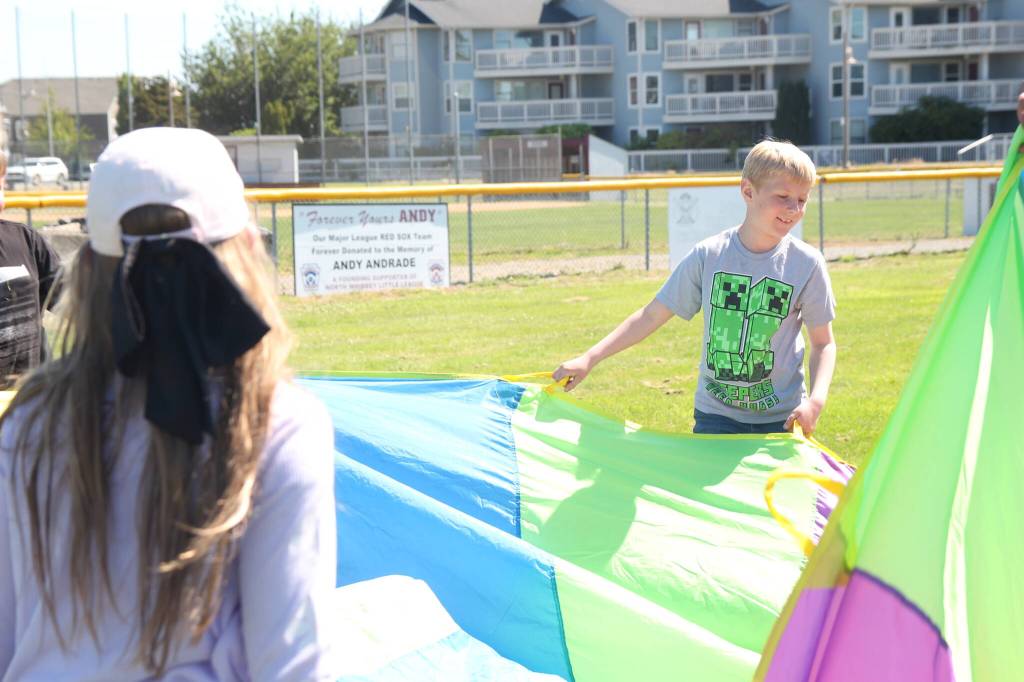 Campers play with a parachute (Photo by Marina Blatt)
