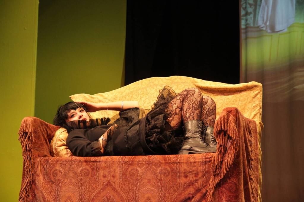 (Photo by Marina Blatt) Liv Phillips as Lydia Deetz lies on a couch, missing her dead mom.