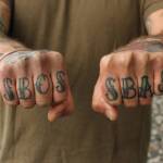 (Photo by Allyson Ballard) Faulises tattoos spell SBOS and SBAS, which stand for Sailors Belong On Ships and Ships Belong At Sea.