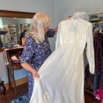 (Photo by Marina Blatt) Parrish holds up her wedding dress for sale.