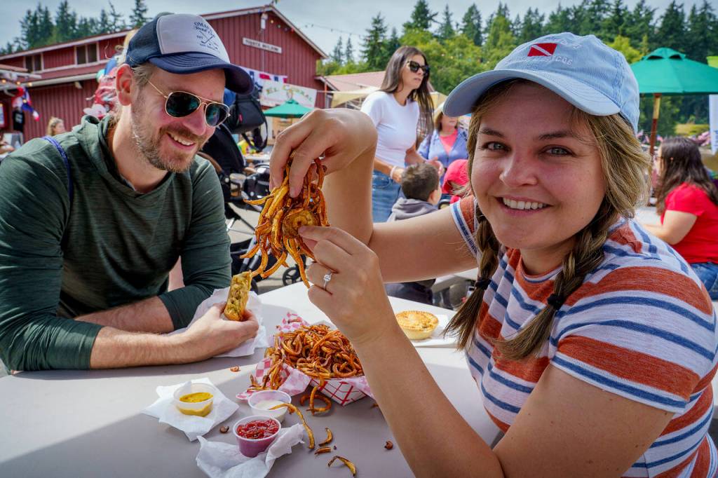 Fairgoers enjoy plenty of curly fries.