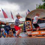 Kids run to the carnival rides.