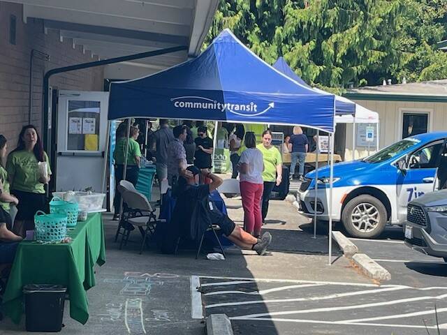 Photo provided
People chat around the community transit booth.