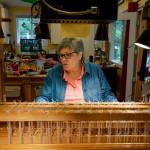 (Photo by David Welton) Clinton weaver Danette Sulgrove sits behind her loom.