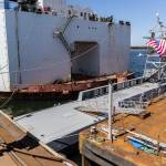 People look at the USX-1 Defiant, a first-of-its-kind autonomous naval ship, at Everett Ship Repair on Monday, Aug. 11, 2025 in Everett, Washington. (Olivia Vanni / The Herald)