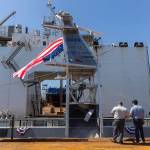 An American flag blows in the wind from the USX-1 Defiant, a first-of-its-kind autonomous naval ship, at Everett Ship Repair on Monday, Aug. 11, 2025 in Everett, Washington. (Olivia Vanni / The Herald)