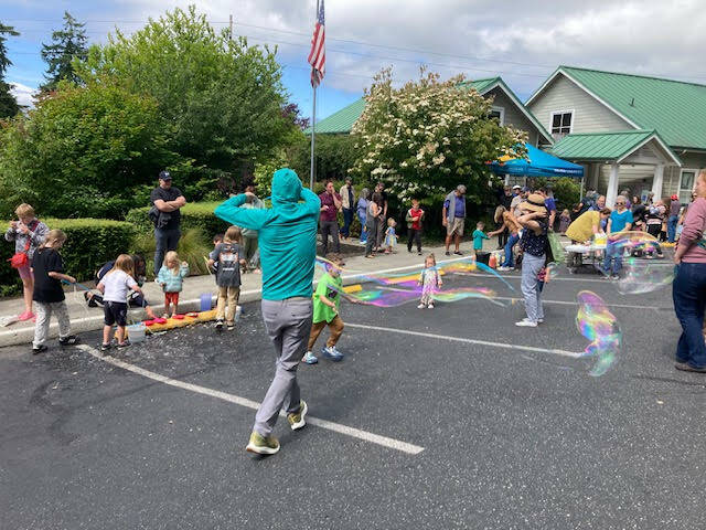 (Photo provided) Community members play with bubbles at a Freeland library event.