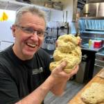 (Photo provided) Clinton Hatton, the soon-to-be new proprietor of the Whidbey Island Bagel Factorys location in Clinton, shapes a Banh Mi dough baby.