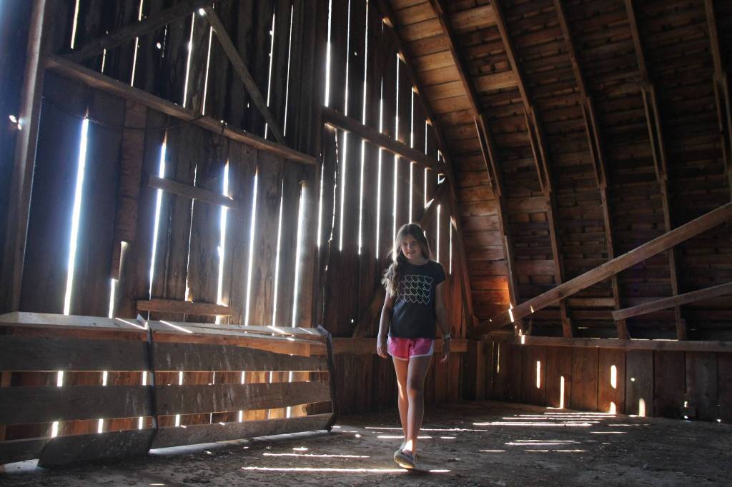(Photo by Marina Blatt) Sadie Riepma walks in between the beams of light in the old barn.
