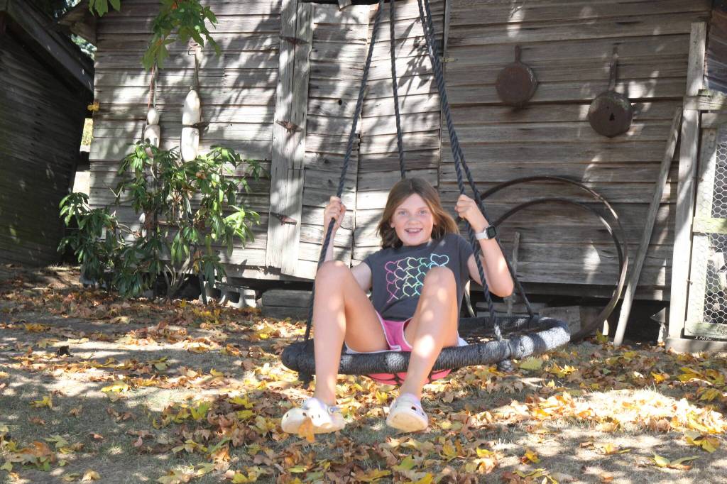 (Photo by Marina Blatt) Sadie Riepma, who is Hank and Ruths granddaughter, is doing one of her favorite activities on the Hilderbink farm.
