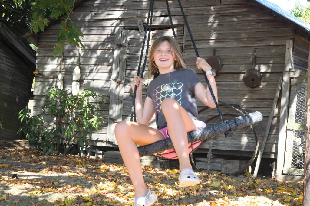 (Photo by Marina Blatt) Sadie enjoys the tire swing on the Hilberdink Farm.