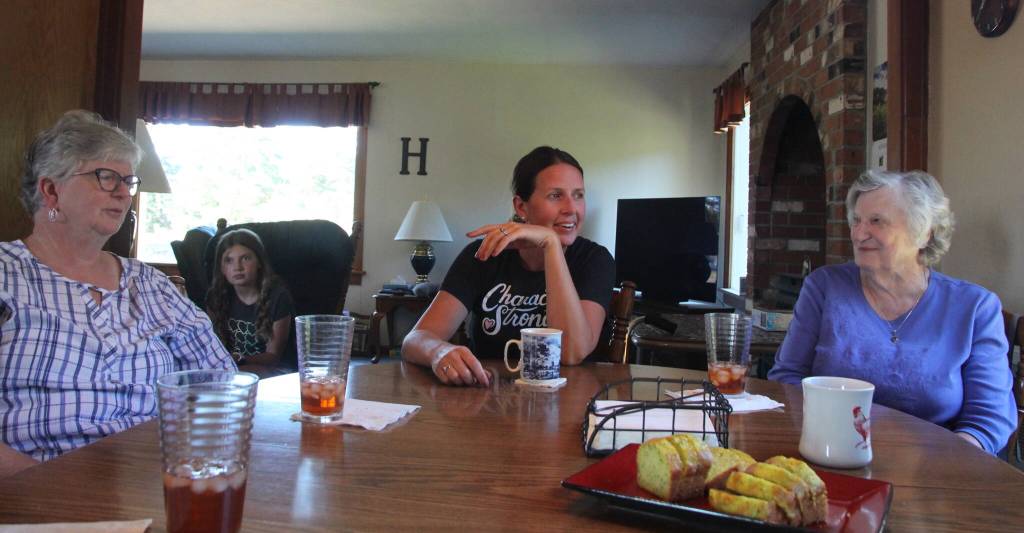 (Photo by Marina Blatt) Three generations of the Hilderbrink family gather around the table.