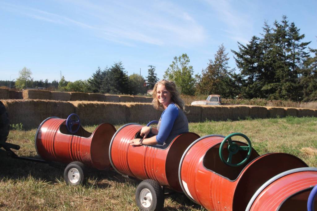 (Photo by Marina Blatt) Shannon Hilborn enjoys a barrel train ride in train carts built by her husband and herself.