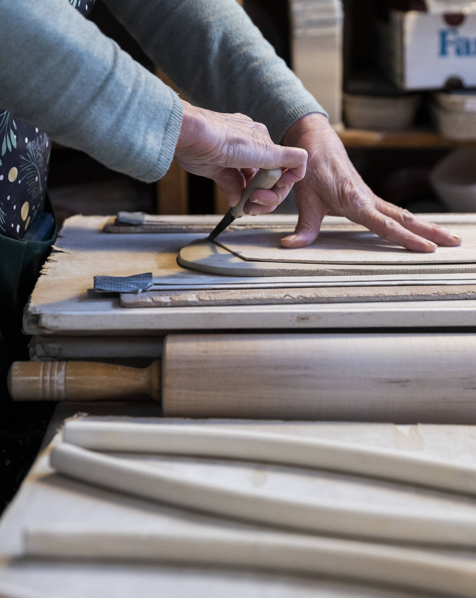Carol Ann Bauer cuts a shape for a platter at her home in Freeland. (Olivia Vanni / The Herald)